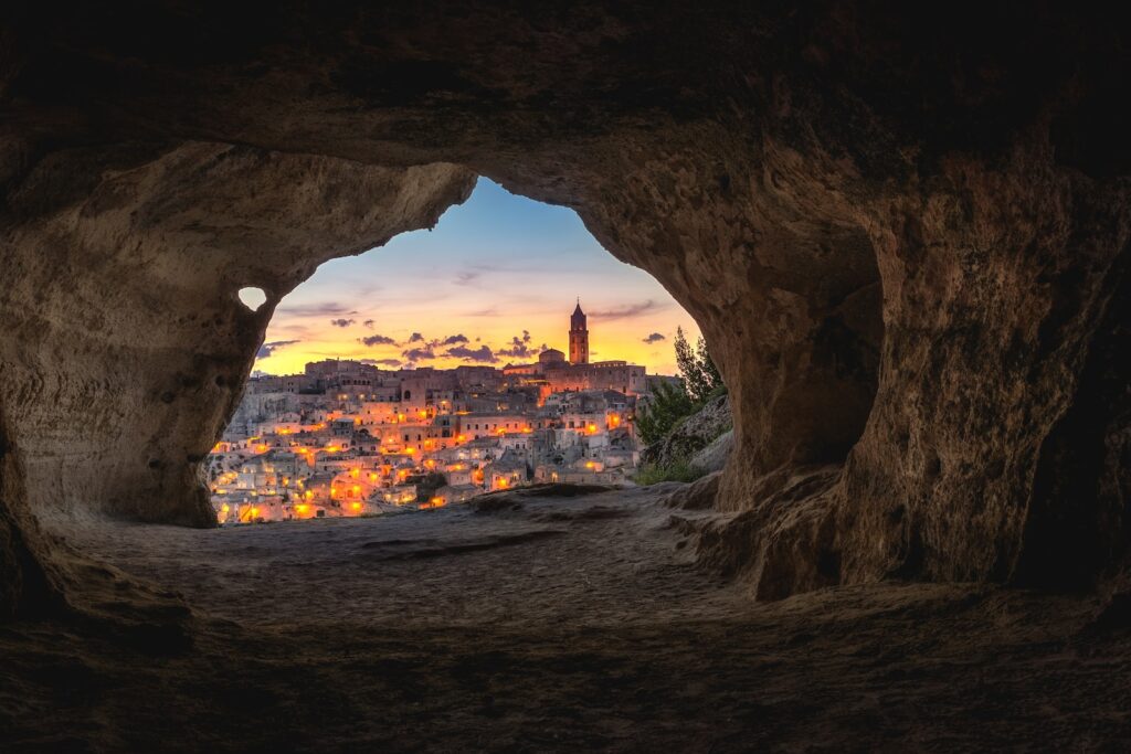 brown cave with over-view of city